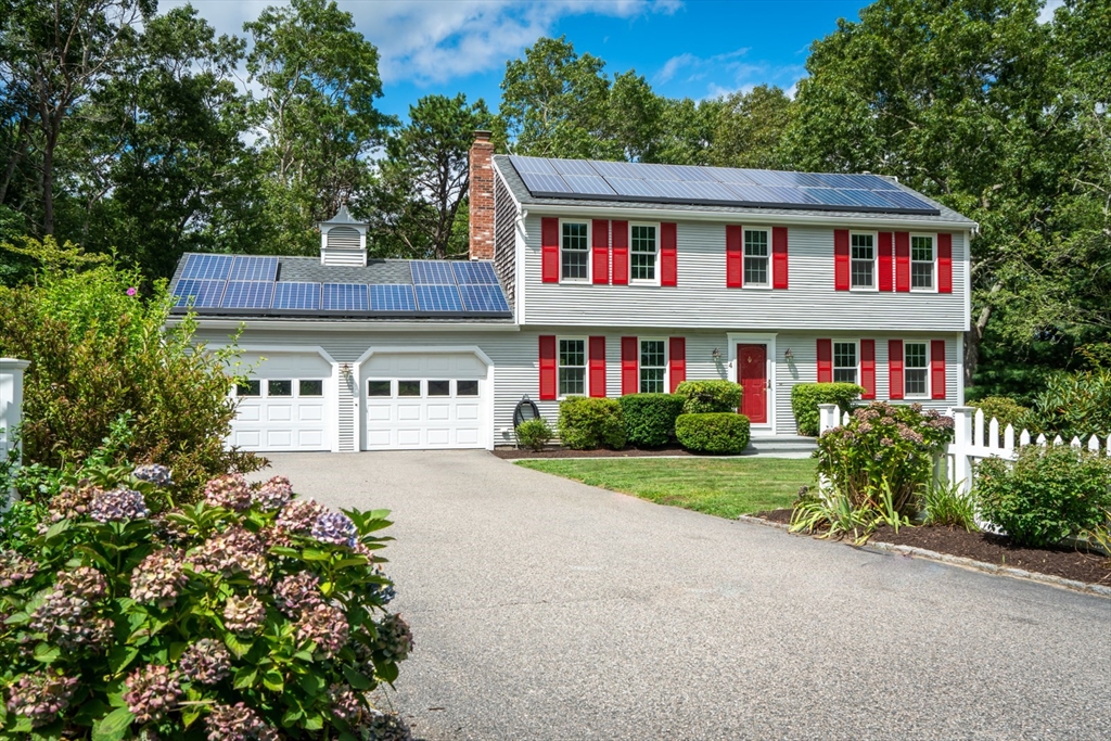 4 Easting Road Bourne, MA 02532 - Photo 1 of 42 a front view of a house with a yard and trees