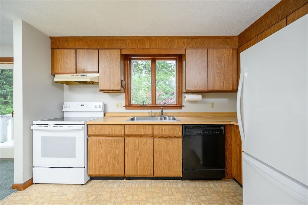 4 Easting Road Bourne, MA 02532 - Photo 16 of 42 a kitchen with a sink stove and cabinets