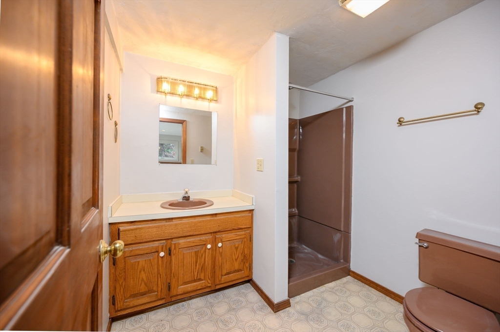 4 Easting Road Bourne, MA 02532 - Photo 30 of 42 a bathroom with a toilet sink and mirror