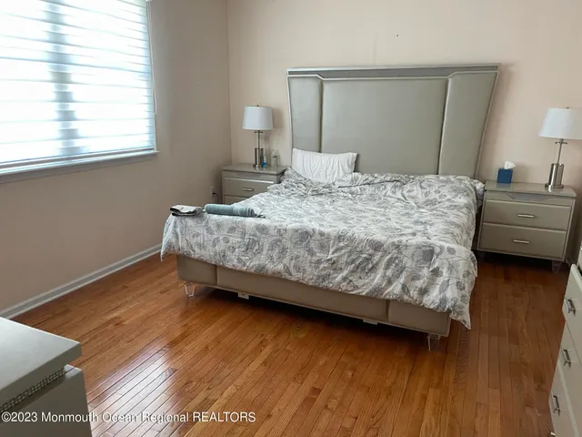 a bedroom with a bed and a night stand