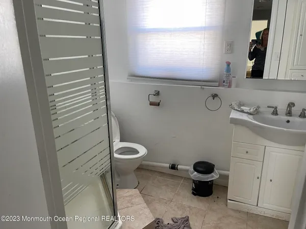 a bathroom with a sink toilet and window