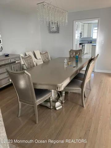a dining room with furniture and wooden floor