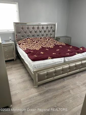 a bed sitting in a bedroom next to a window