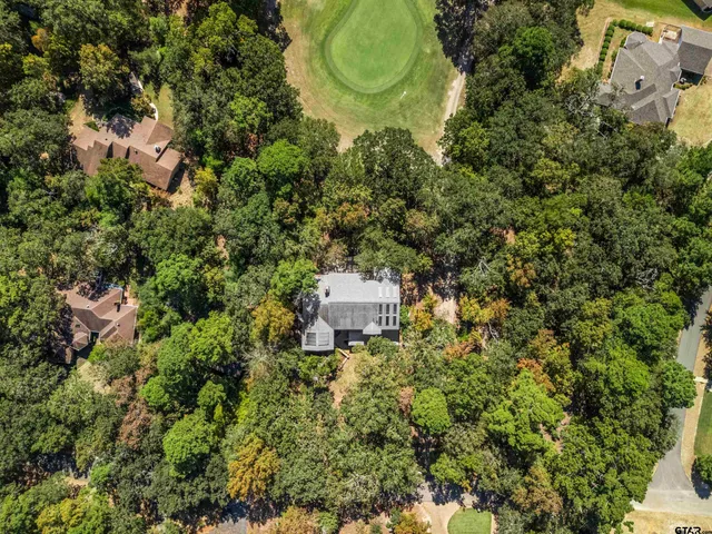 an aerial view of a house with a yard and garden