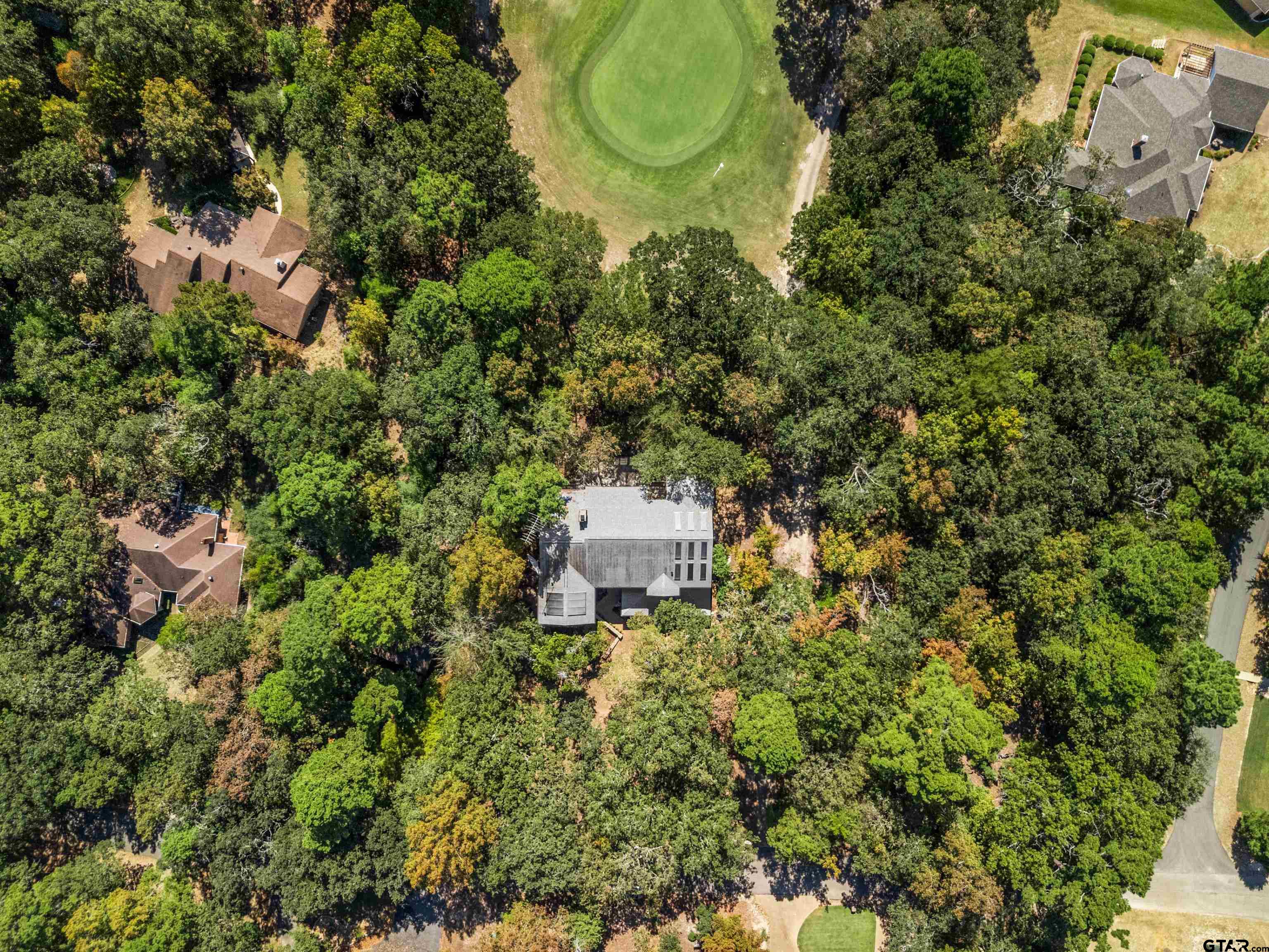 an aerial view of a house with a yard and garden