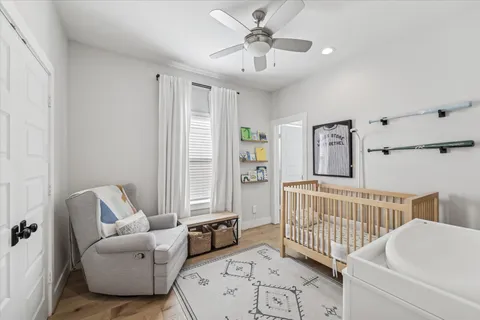 a living room with furniture and a baby crib