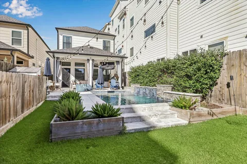a view of an house with backyard and sitting area
