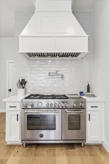 a stove top oven sitting inside of a kitchen