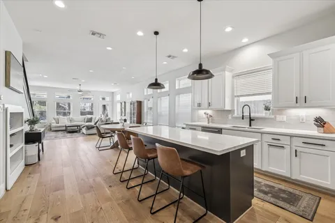 a kitchen with lots of counter top space and painting on the wall