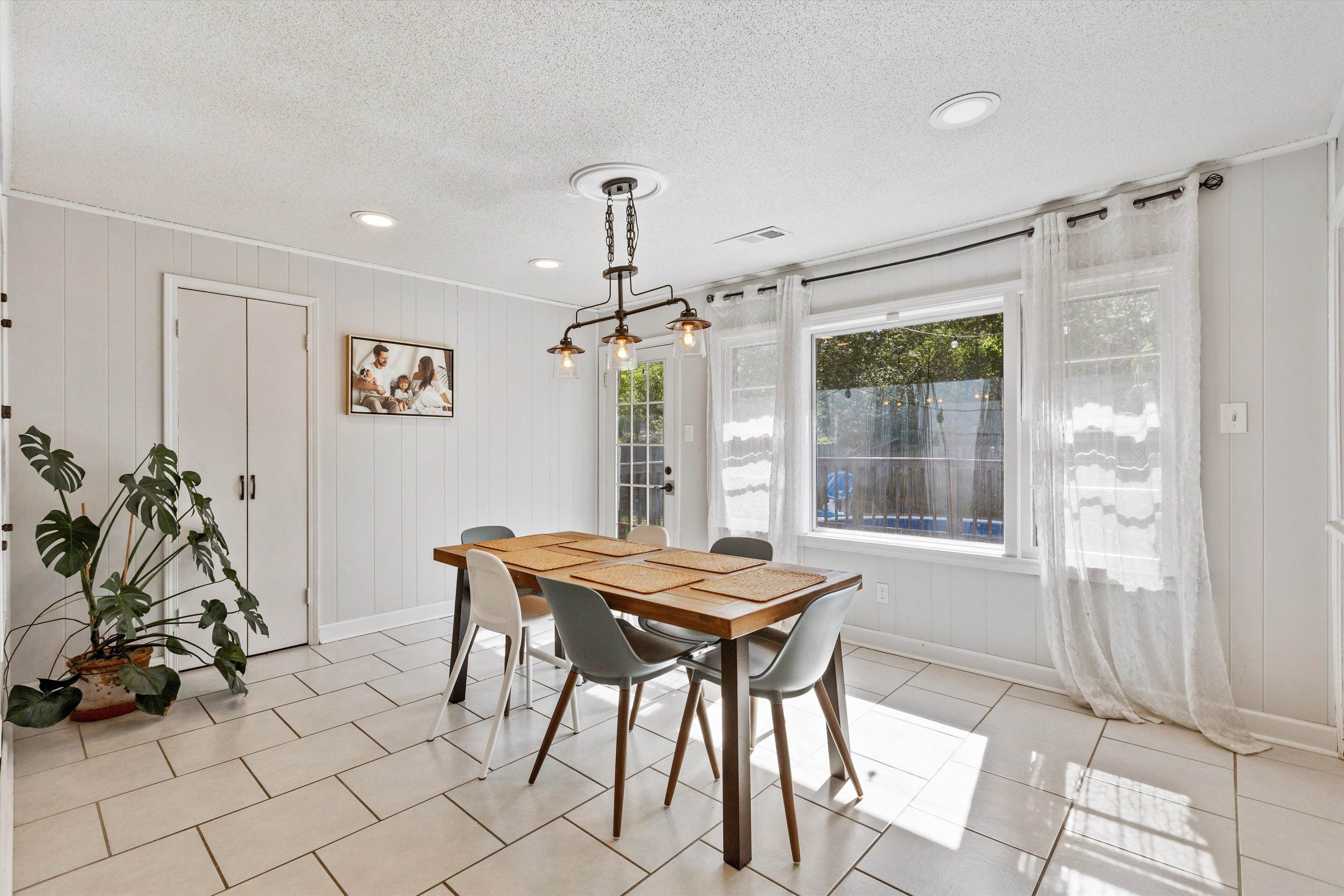 4506 Verne Road Memphis, TN 38117 - Photo 12 of 40 a view of a dining room with furniture and a chandelier