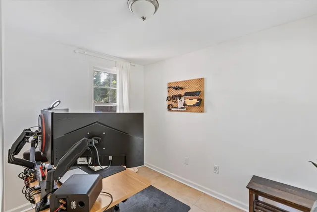 a view of a workspace with furniture and a window