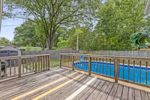 a view of deck with wooden floor and fence