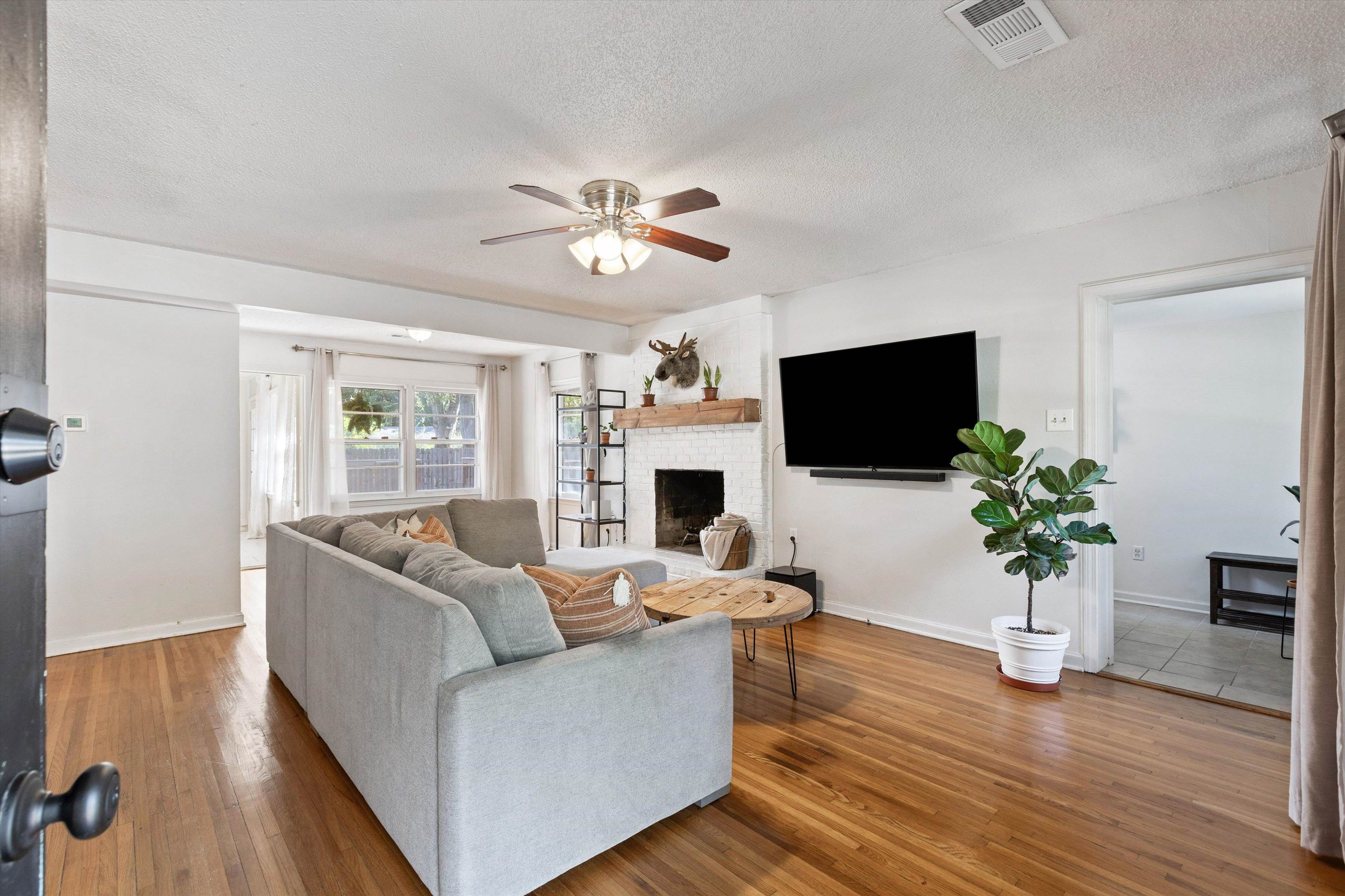 4506 Verne Road Memphis, TN 38117 - Photo 3 of 40 a living room with furniture a flat screen tv and a fireplace