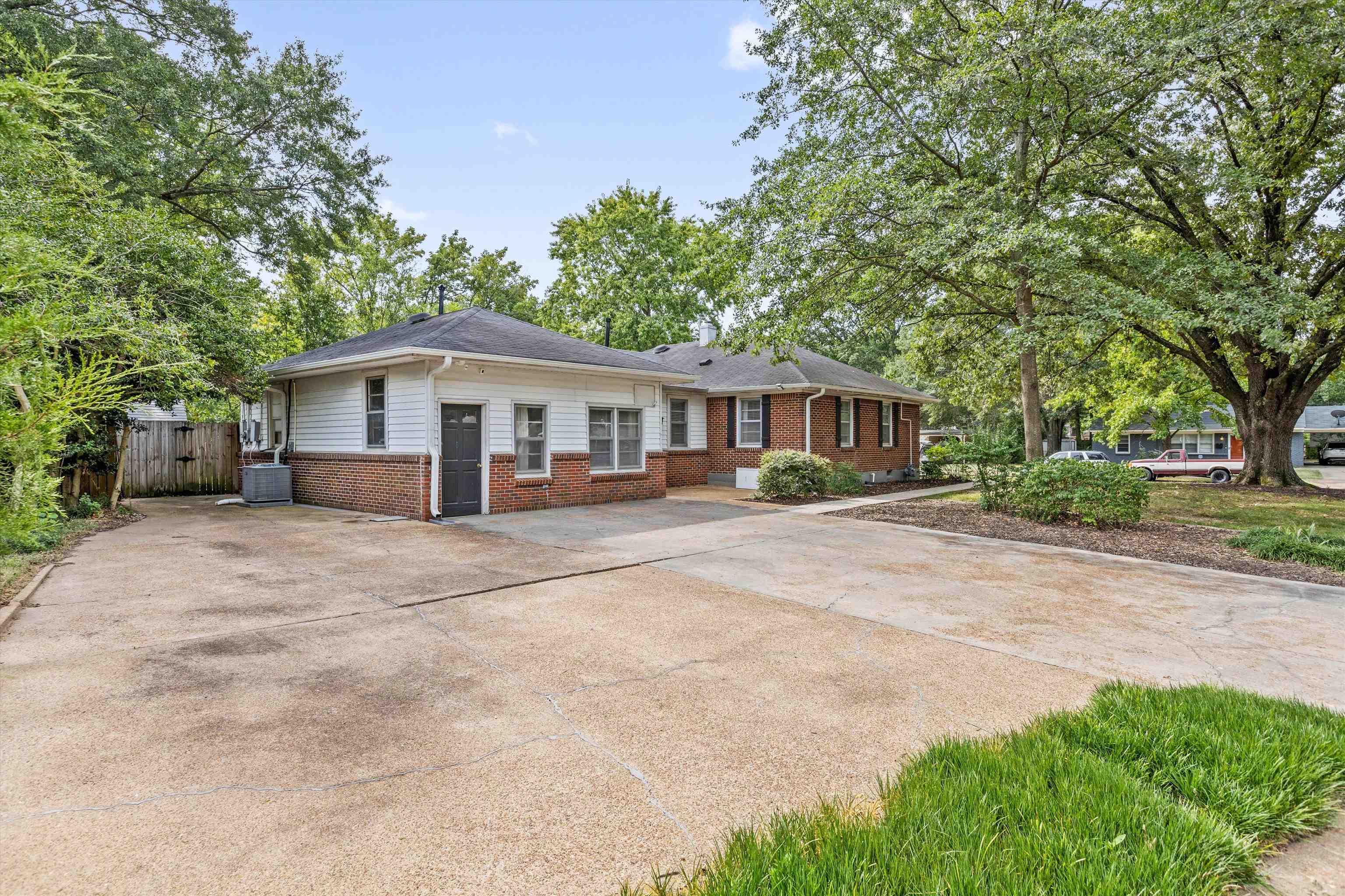 4506 Verne Road Memphis, TN 38117 - Photo 39 of 40 a front view of a house with a yard and trees