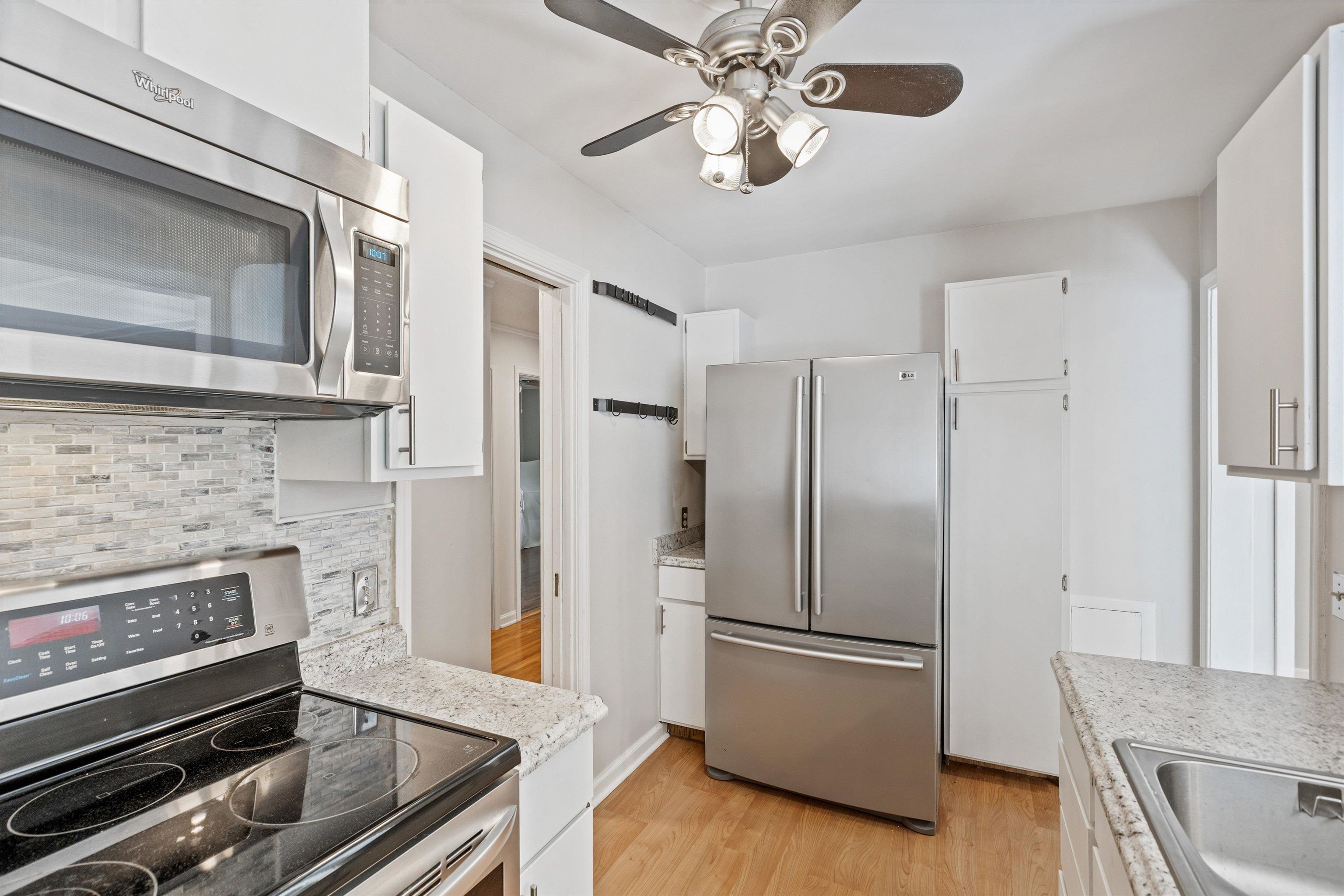 4506 Verne Road Memphis, TN 38117 - Photo 8 of 40 a kitchen with stainless steel appliances granite countertop a refrigerator a stove and a microwave oven