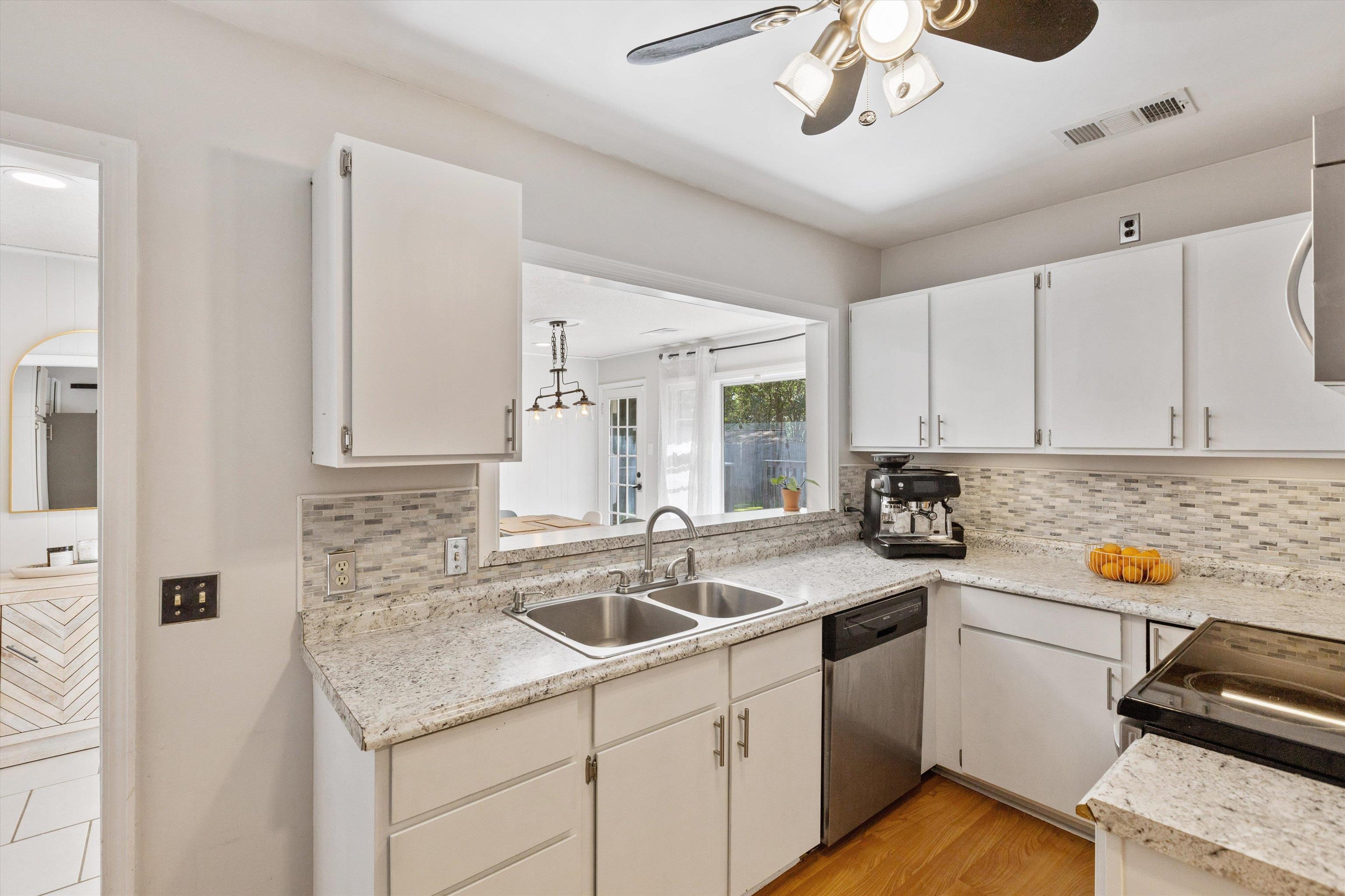 4506 Verne Road Memphis, TN 38117 - Photo 10 of 40 a kitchen with stainless steel appliances granite countertop a sink and dishwasher with white cabinets