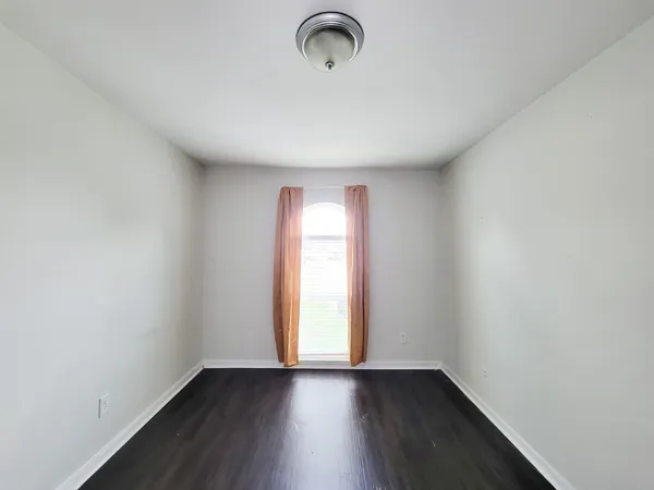 a view of room with window and hardwood floor