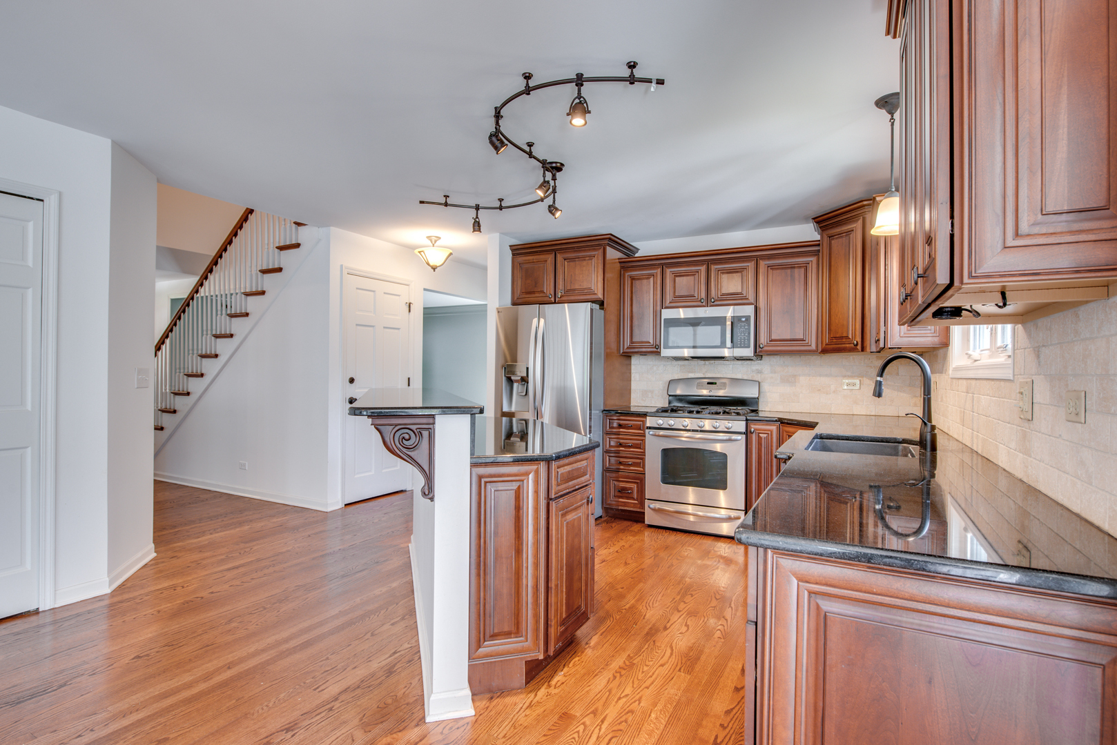 3631 Falkner Drive Naperville, IL 60564 - Photo 18 of 45 a kitchen with stainless steel appliances granite countertop a refrigerator a sink dishwasher a stove and white countertops with wooden floor