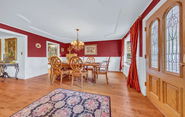 a view of a dining room with furniture and chandelier