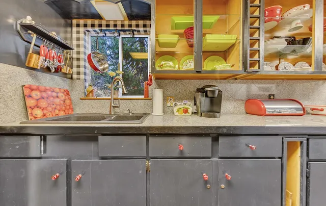a utility room with lots of clutter and cabinets