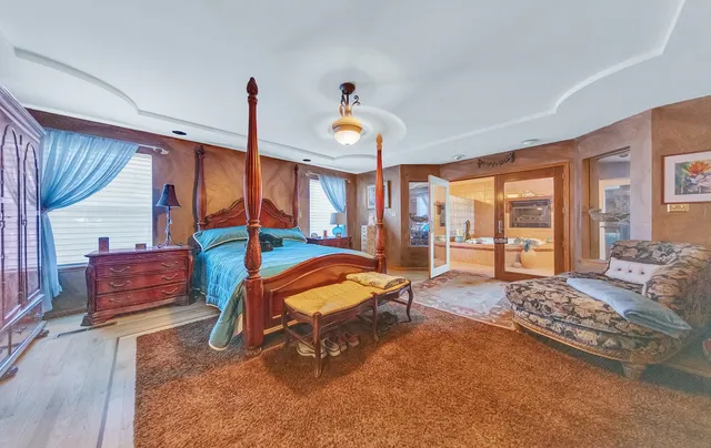 a bedroom with furniture and a large window