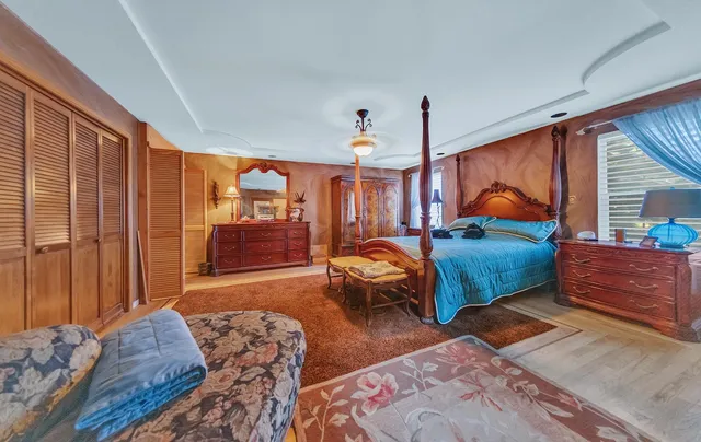 a bedroom with furniture and large window