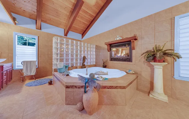 a dining room with furniture a window and potted plants