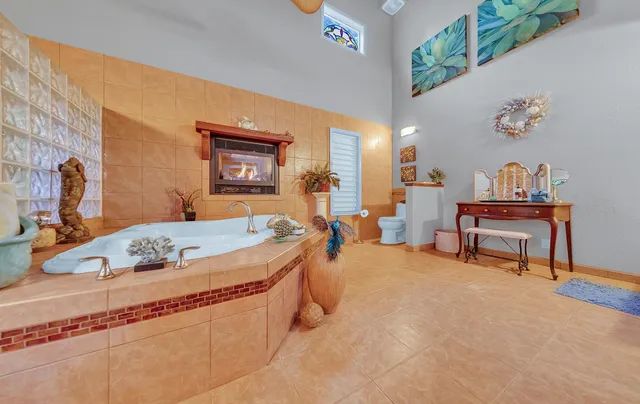 a bed sitting in a room next to a lamp