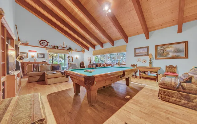 a living room with furniture a rug and a chandelier