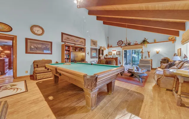a living room with furniture a rug and a clock