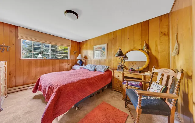 a bed room with a bed chair and a window