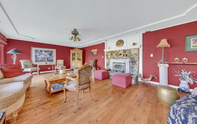 a living room with fireplace furniture and wooden floor