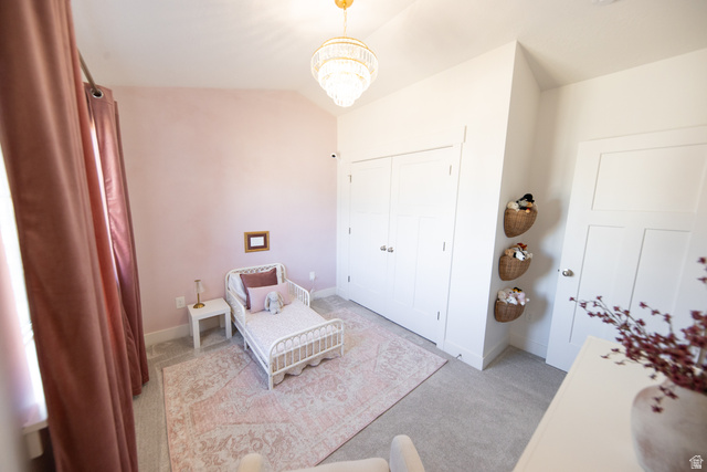 1404 East Rustic Wood Court Sandy, UT 84092 - Photo 22 of 33 Bright room featuring a vaulted ceiling and a crystal chandelier