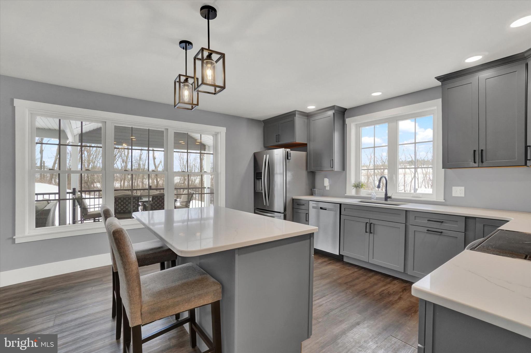 1048 Keller Road York, PA 17406 - Photo 10 of 28 a kitchen with stainless steel appliances granite countertop a kitchen island hardwood floor sink stove and dining table