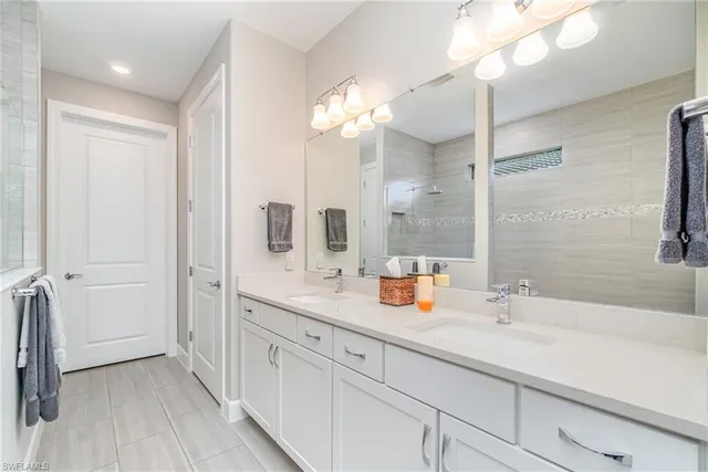 a bathroom with a double vanity sink and mirror