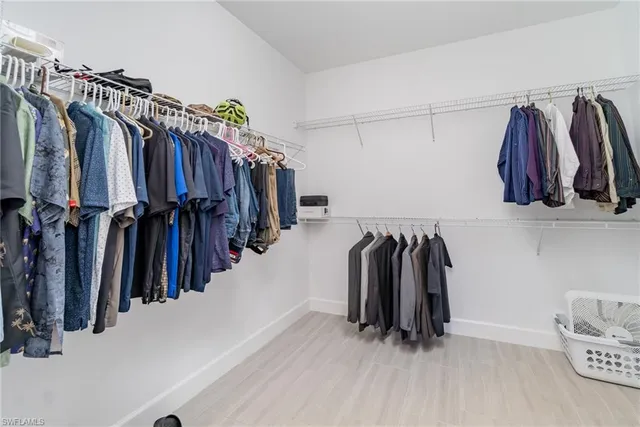 a bathroom with a sink a light fixture and a mirror