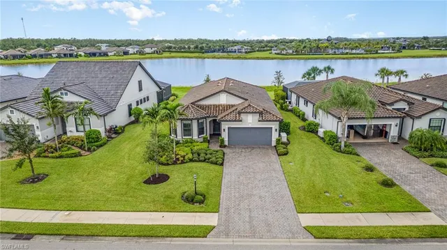an aerial view of a house with big yard and large tree