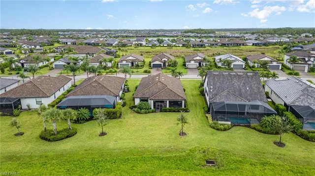 an aerial view of residential houses with outdoor space and swimming pool