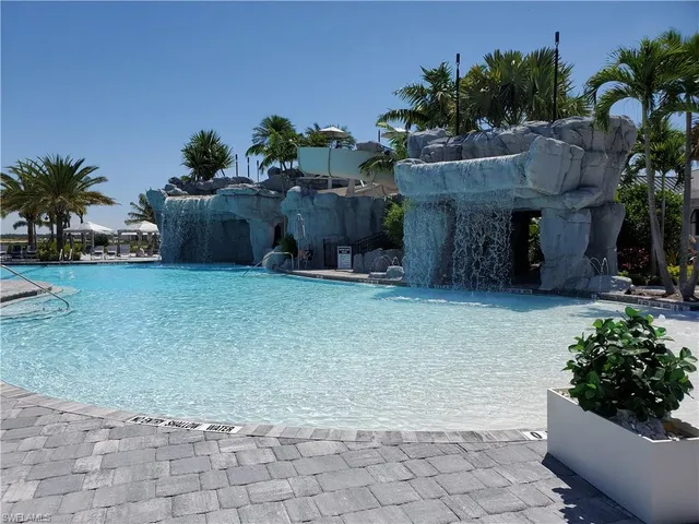 a backyard of a house with lots of green space and fountain