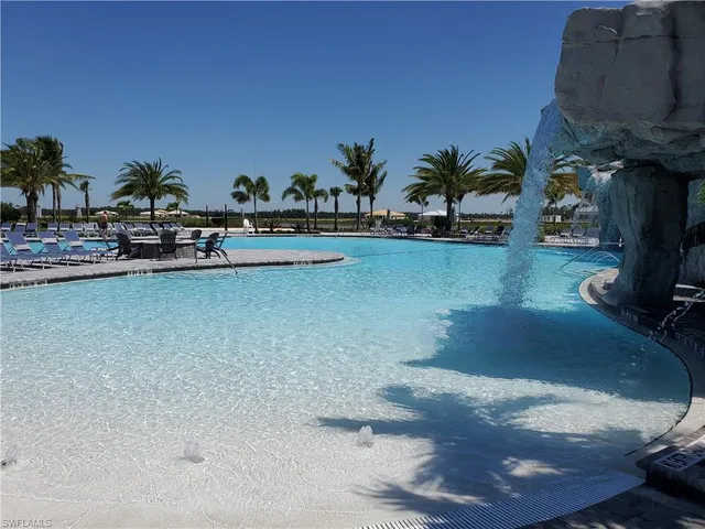 a view of a swimming pool with lawn chairs