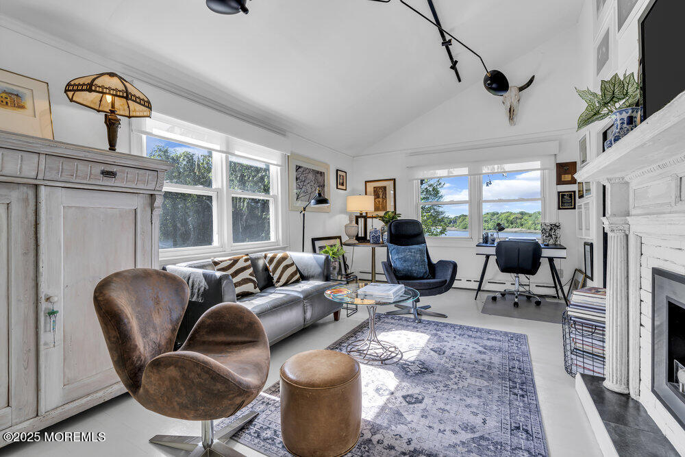 638 South Riverside Drive Neptune Township, NJ 07753 - Photo 20 of 41 a living room with furniture a fireplace and a flat screen tv