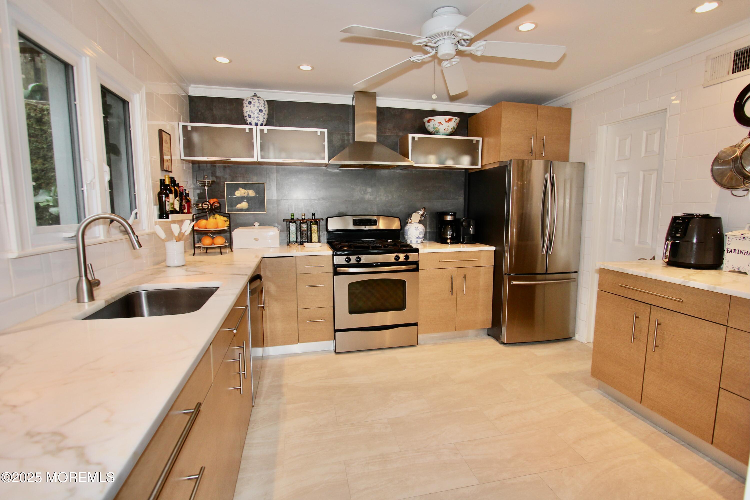 638 South Riverside Drive Neptune Township, NJ 07753 - Photo 22 of 41 a kitchen with granite countertop a refrigerator oven a sink and dishwasher