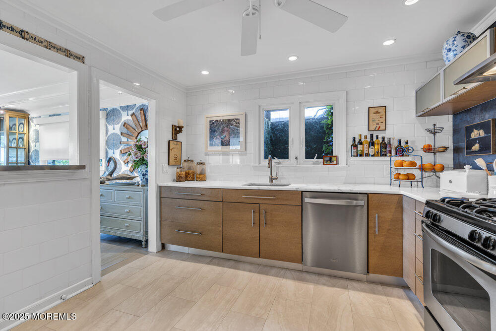 638 South Riverside Drive Neptune Township, NJ 07753 - Photo 23 of 41 a kitchen with stainless steel appliances granite countertop a sink and cabinets