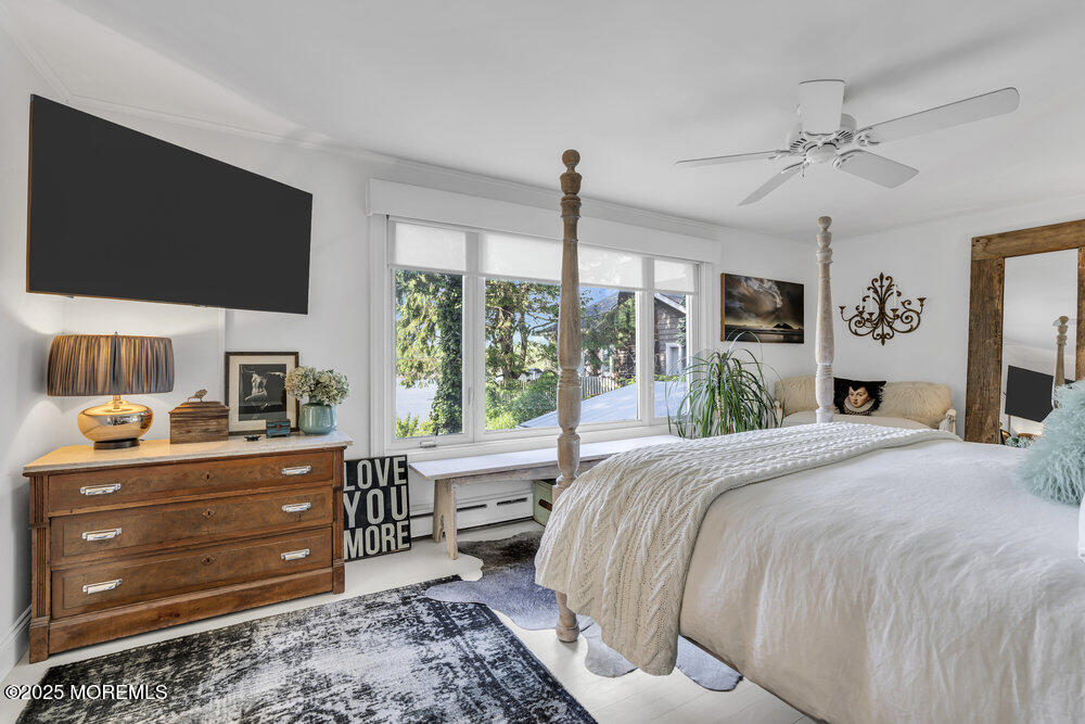 638 South Riverside Drive Neptune Township, NJ 07753 - Photo 27 of 41 a bedroom with a bed and a flat screen tv
