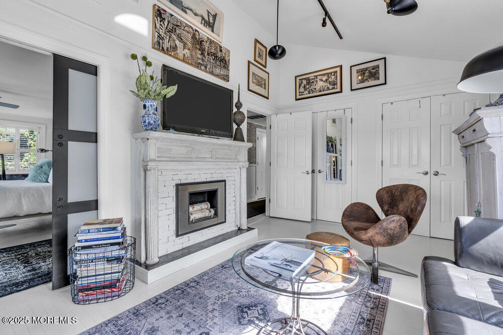 638 South Riverside Drive Neptune Township, NJ 07753 - Photo 28 of 41 a living room with furniture a flat screen tv and a fireplace
