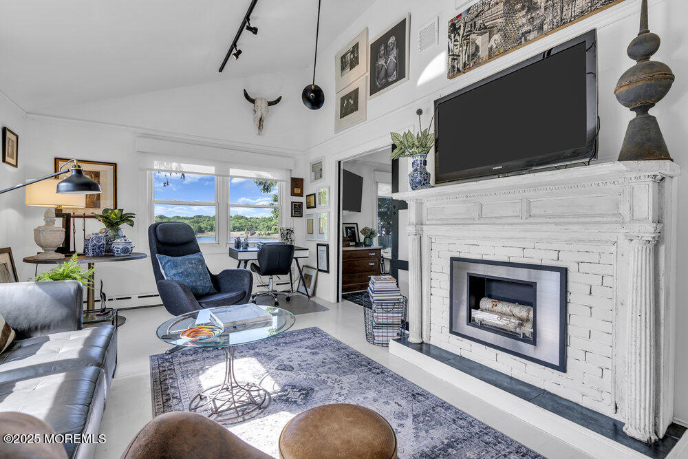 638 South Riverside Drive Neptune Township, NJ 07753 - Photo 29 of 41 a living room with furniture a flat screen tv and a fireplace