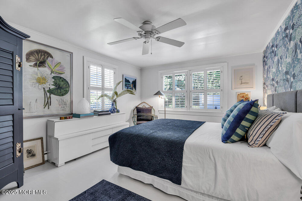 638 South Riverside Drive Neptune Township, NJ 07753 - Photo 32 of 41 a spacious bedroom with a large bed and a window
