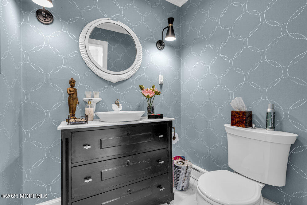 638 South Riverside Drive Neptune Township, NJ 07753 - Photo 35 of 41 a bathroom with a toilet a sink and mirror