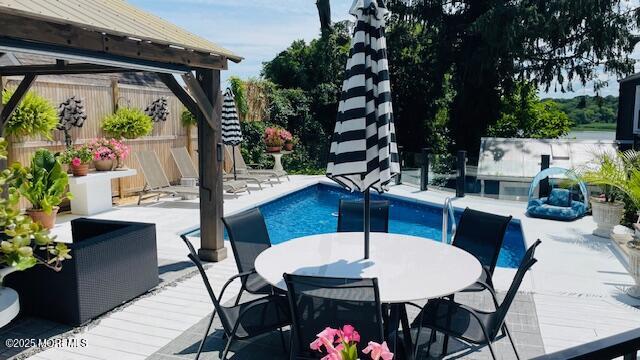 638 South Riverside Drive Neptune Township, NJ 07753 - Photo 8 of 41 a view of an outdoor dining space with a table and chairs