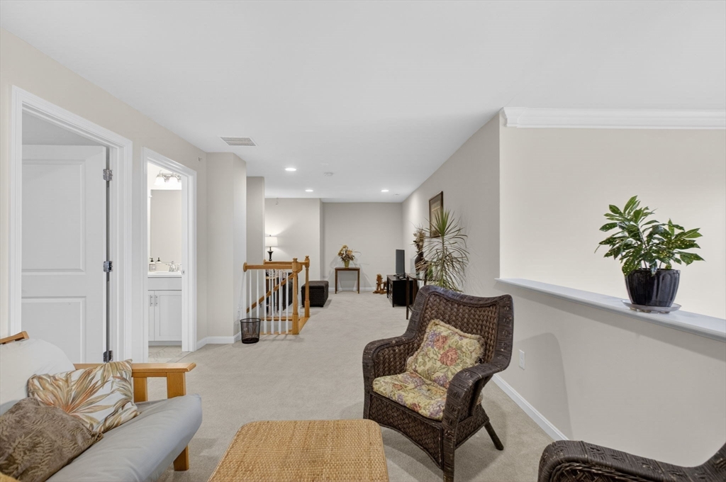 87 Shannon Way, Unit 86 Upton, MA 01568 - Photo 21 of 36 a living room with furniture and wooden floor